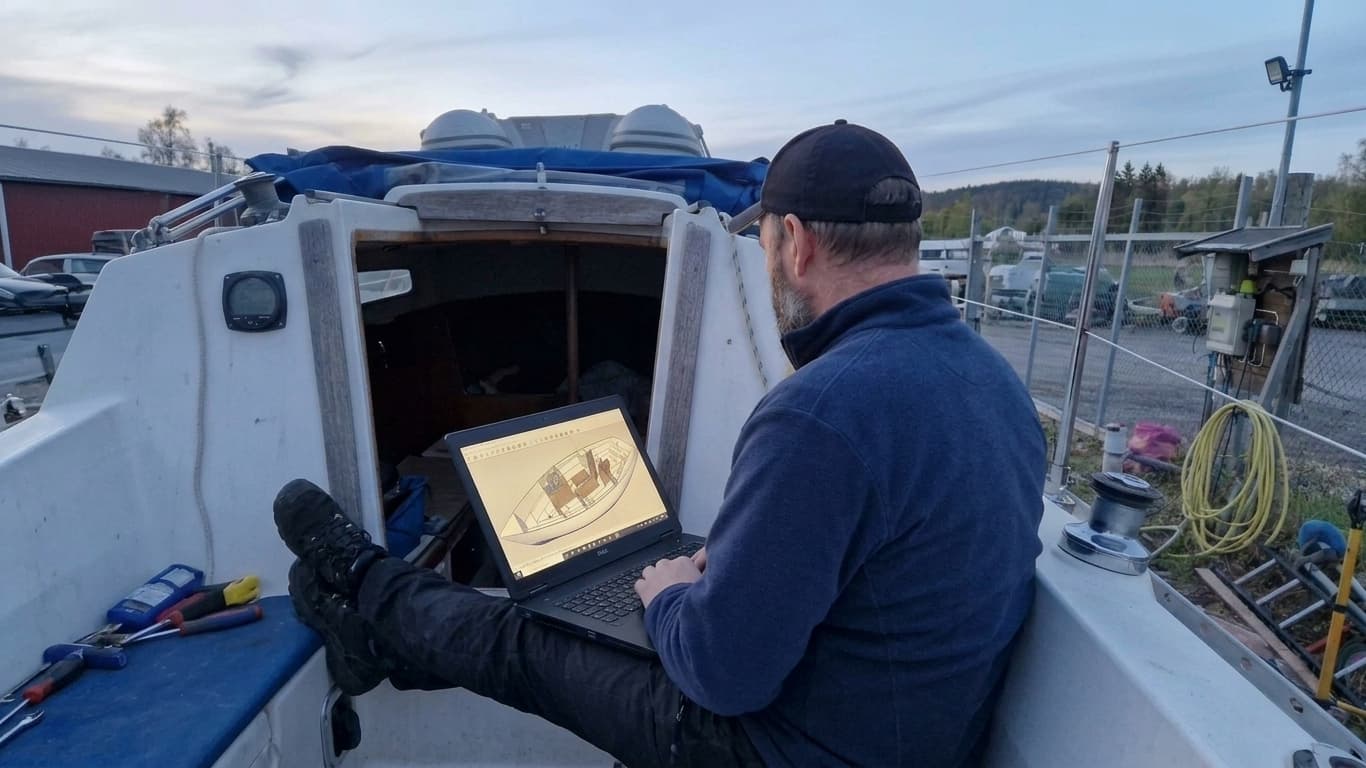 Vsevolod working on yacht interior design in SketchUp on a laptop, on board a vessel